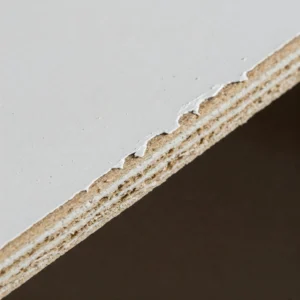 Example of edge chipping on a melamine coated panel during cutting